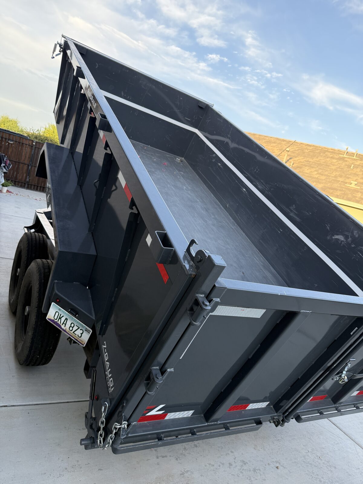 Dump trailer raised, unloading debris on the jobsite