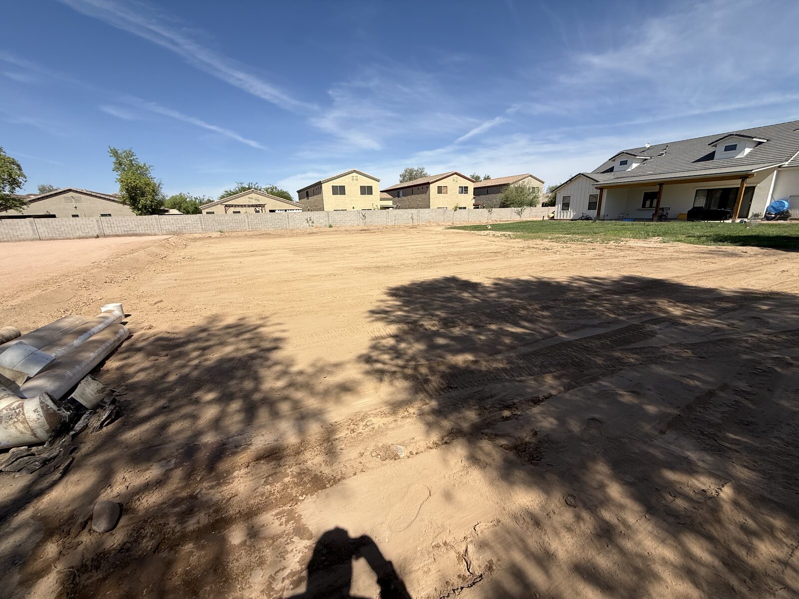 Bobcat skid steer grading a pad in the Phoenix metro