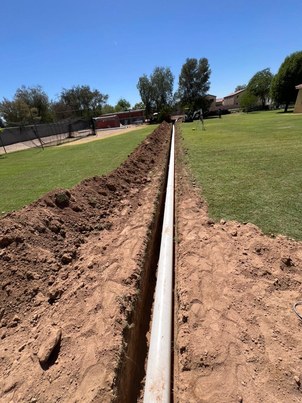 Trench dug for a drainage line across a Peoria yard