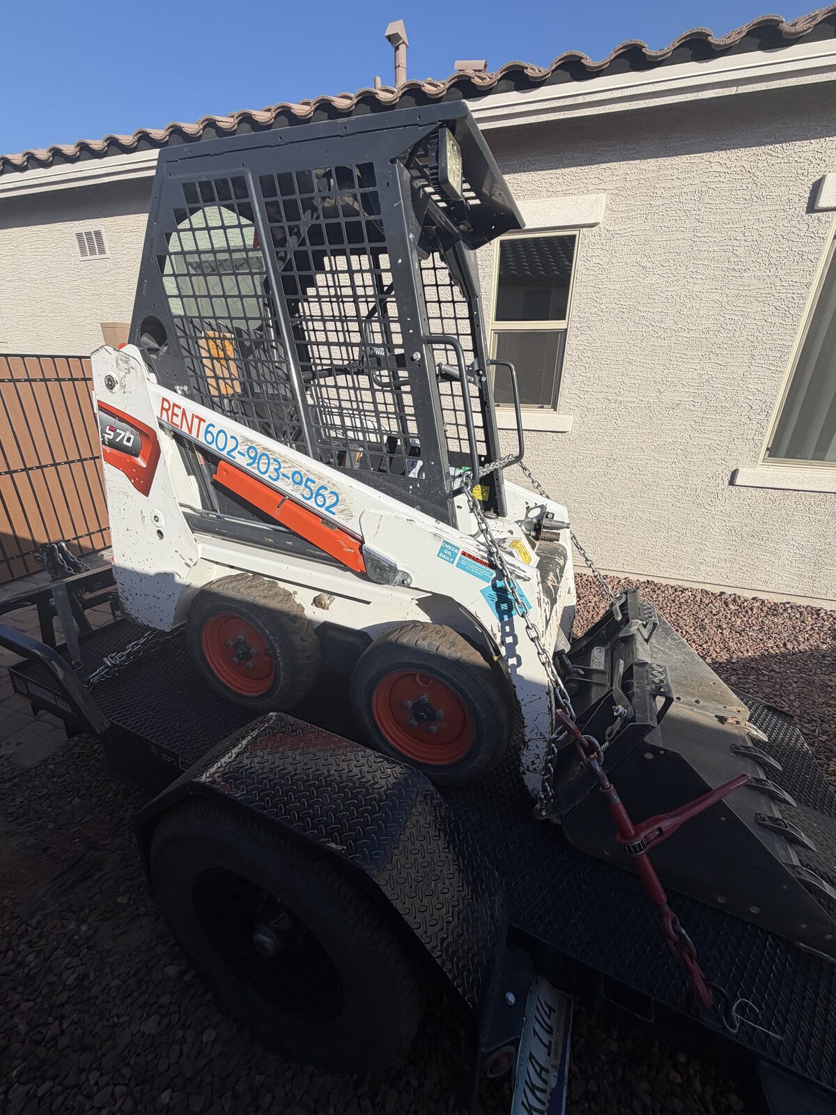Ridgeline tilt trailer loaded with a Bobcat skid steer in Peoria, AZ
